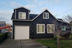 Reroofing in Renton, WA on a home with dark siding