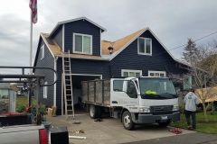 Roofers reroofing a home in Renton, WA