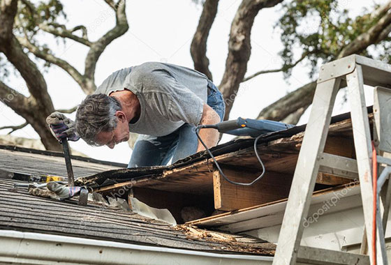 Emergency roof repair in Kent, WA, being inspected for damage under the shingles